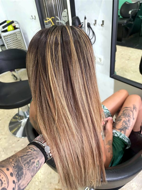 Melena larga lisa con balayage rubio sobre base castaña en True Elegance, peluquería unisex en Algeciras